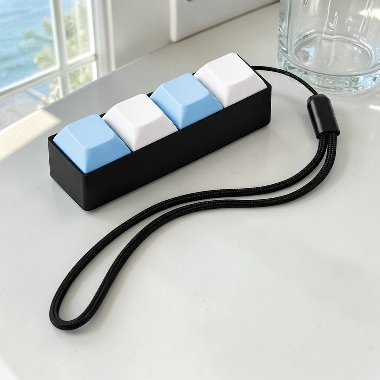Keyboard fidget with blue and white keycaps on a light surface