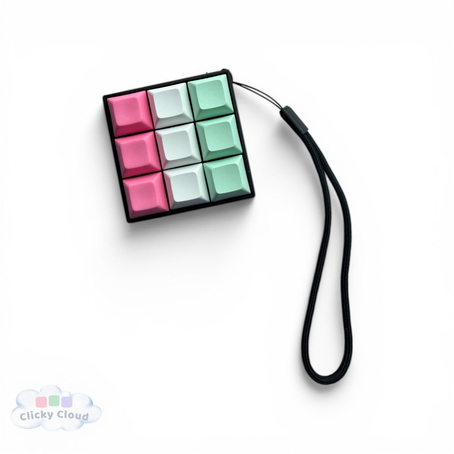 Colorful key clicker keychain with a black strap on a white background