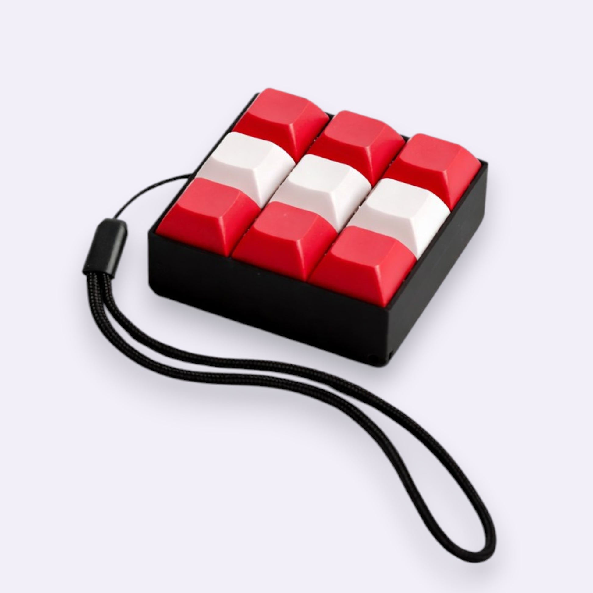 Keychain with red and white keys on a black base against a white background