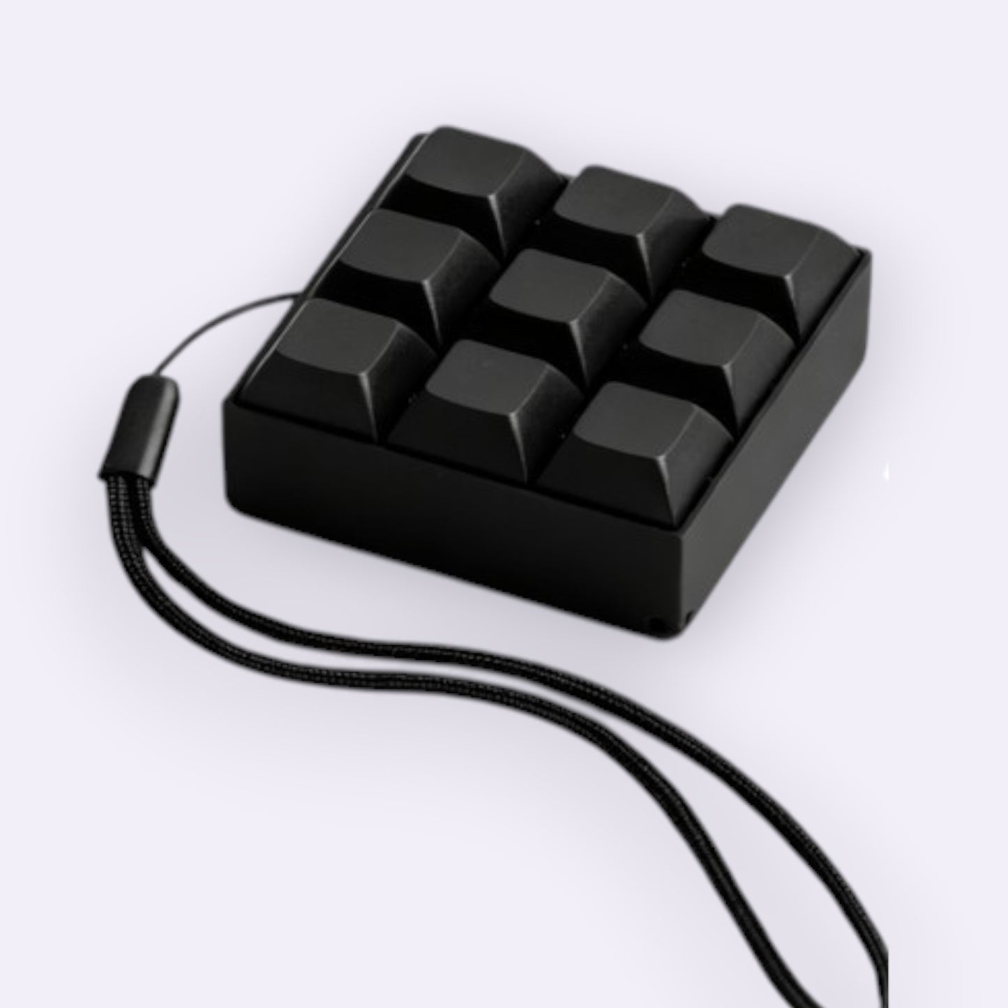 Black keyboard fidget  clicker with a cord on a white background
