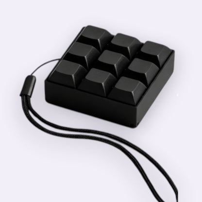 Black keyboard fidget  clicker with a cord on a white background