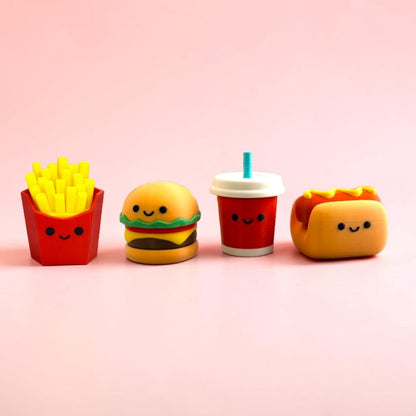 Set of cute clicky toys resembling French fries, burger, drink, and hot dog on a pink background