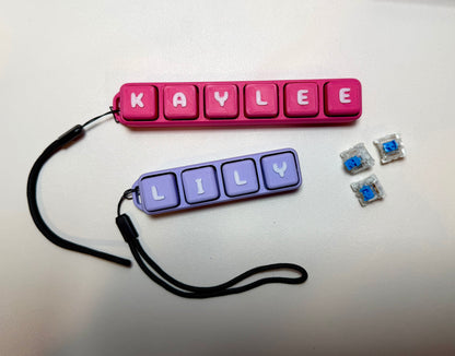 Pink and purple name tags with 'KAYLIEE' and 'LILLY' on a white background