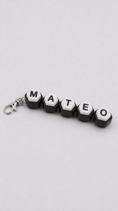 Keychain with letter beads spelling 'MATEO' on a light gray background