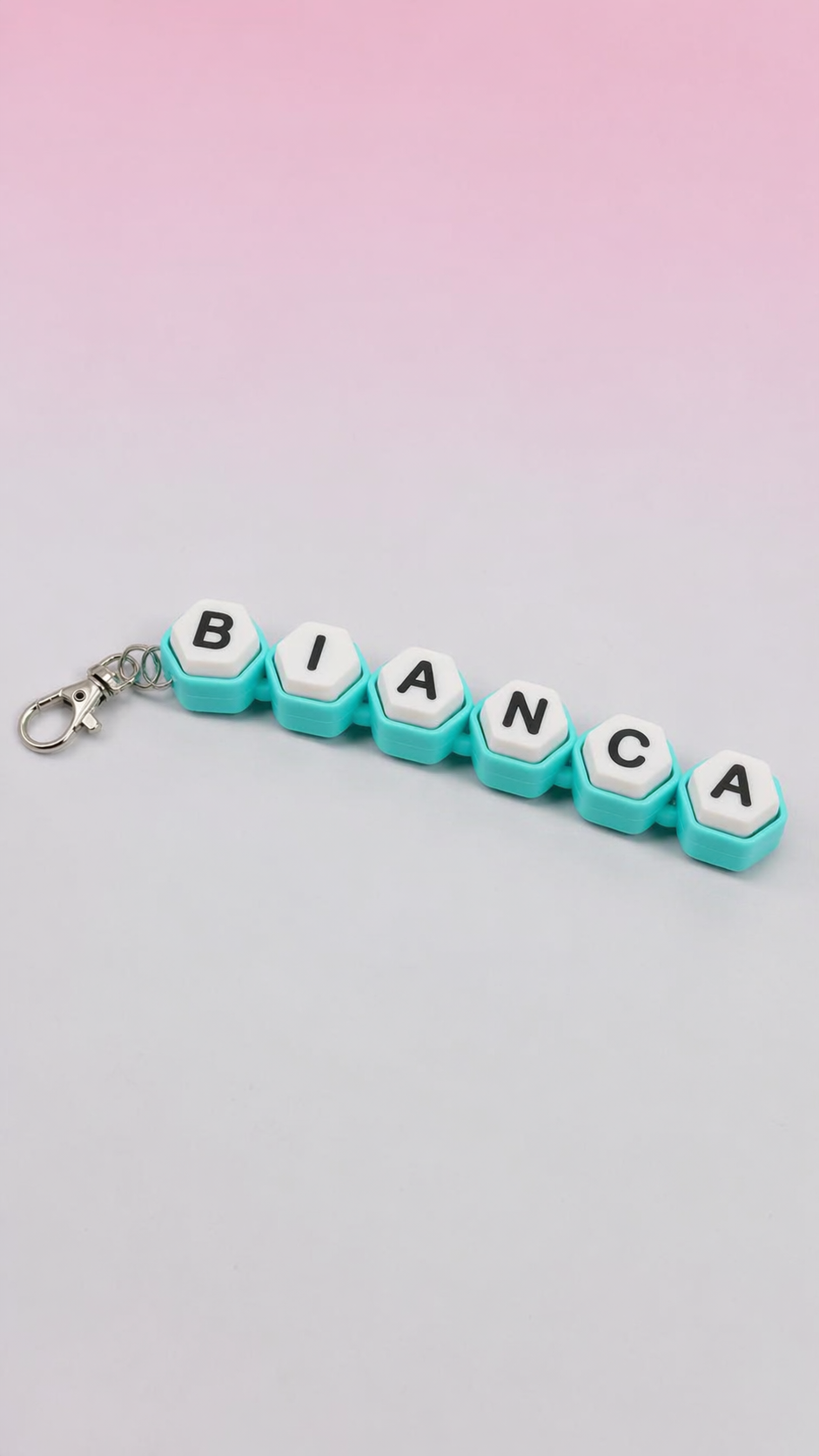 Keychain with letter tiles spelling 'BIANCA' against a gradient background
